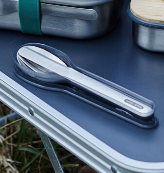 Portable steel cutlery set on a camping table